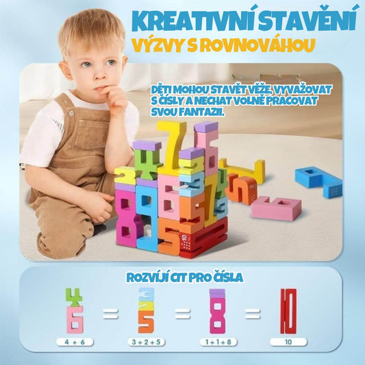 Malé dítě u kreativního stavění věží z barevných číselných kostek s ukázkou rozvíjení citu pro čísla a rovnováhu.